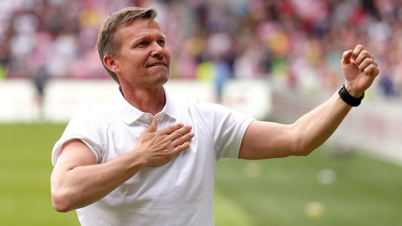Leeds United manager Jesse Marsch celebrates survival with the fans after the Premier League match at The Brentford Community Stadium, London. Picture date: Sunday May 22, 2022.