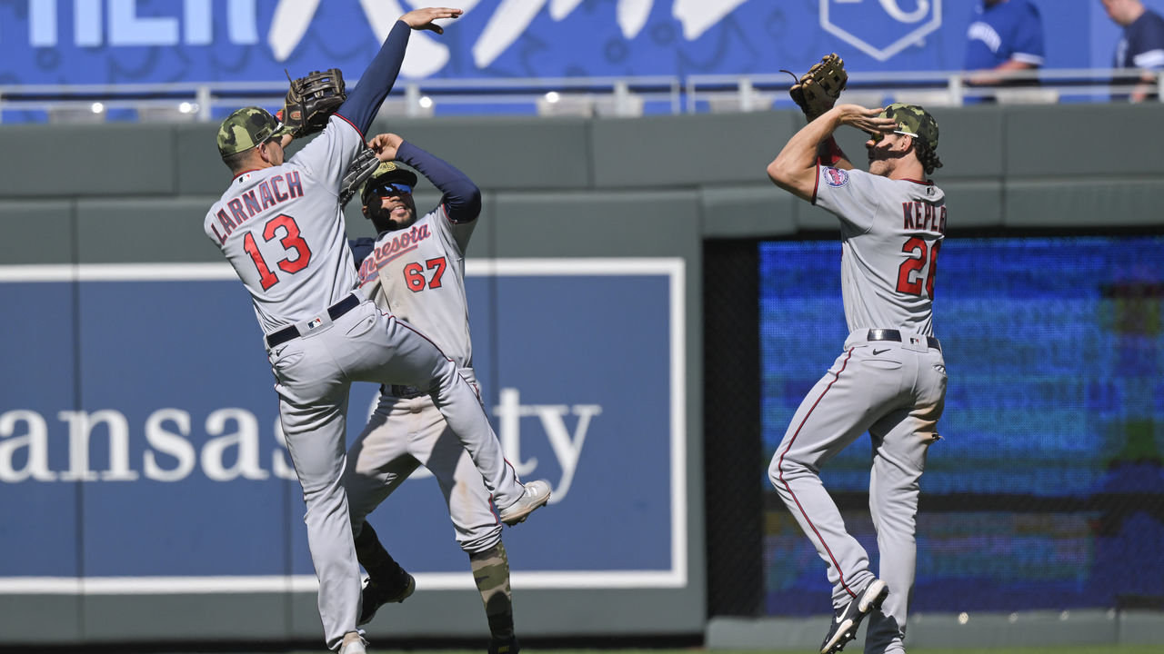 KANSAS CITY, MO - MAY 22: Outfielders Trevor Larnach #13, Gilberto Celestino #67 and Max Kepler #26 of the Minnesota Twins celebrate after their 7-6 win over the Kansas City Royals at Kauffman Stadium on May 22, 2022 in Kansas City, Missouri.