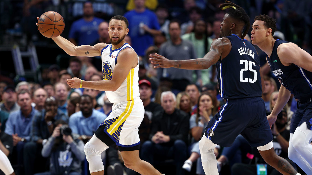 DALLAS, TEXAS - MAY 22: Stephen Curry #30 of the Golden State Warriors looks to pass the ball against Reggie Bullock #25 and Dwight Powell #7 of the Dallas Mavericks during the second quarter in Game Three of the 2022 NBA Playoffs Western Conference Finals at American Airlines Center on May 22, 2022 in Dallas, Texas.