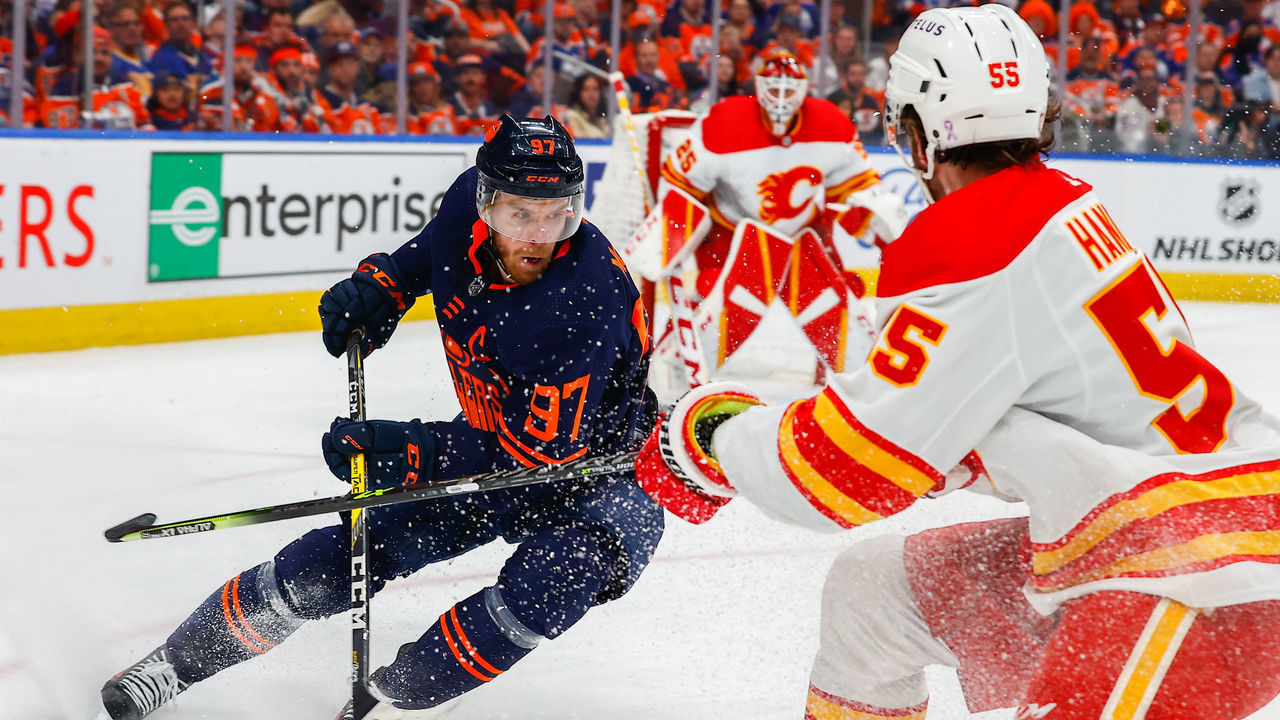 EDMONTON, AB - MAY 22: Edmonton Oilers Center Connor McDavid (97) spins to get away from Calgary Flames Defenceman Noah Hanifin (55) in the first period during the Edmonton Oilers versus the Calgary Flames in the Stanley Cup playoffs round 2, game 3 on May 22, 2022 at Rogers Place in Edmonton, AB.