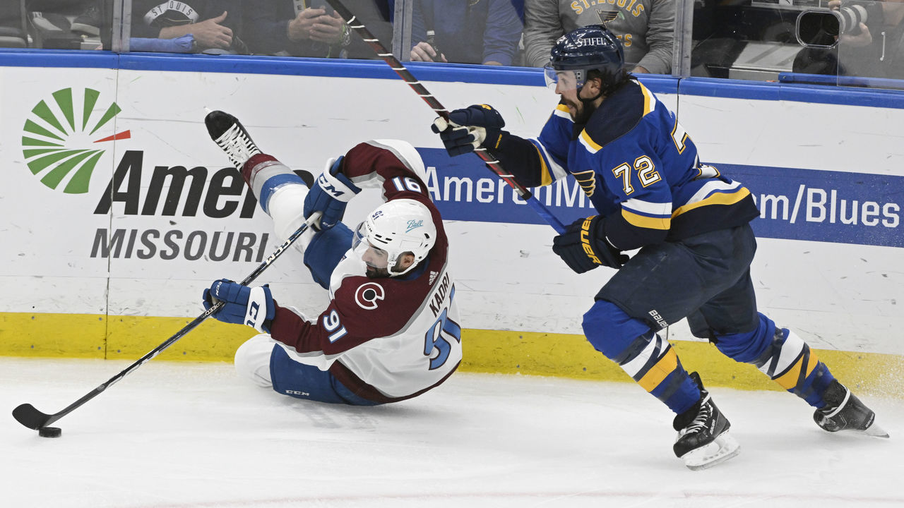 ST. LOUIS, CO - MAY 21: Colorado Avalanche center Nazem Kadri (91) goes after the puck after falling against St. Louis Blues defenseman Justin Faulk (72) in the second period at The Enterprise Center during game three of the second round of the NHL playoffs at the Enterprise Center May 21, 2022. "n