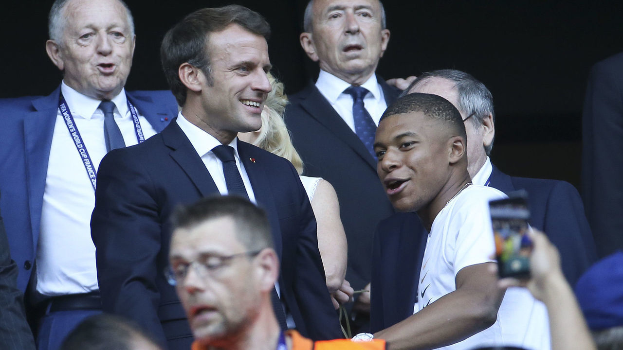 LYON, FRANCE - JULY 7: President of France Emmanuel Macron chats with Kylian Mbappe of Paris Saint-Germain while above them President of Olympique Lyonnais Jean-MIchel Aulas and Mayor of Lyon Gerard Collomb look on prior to the 2019 FIFA Women's World Cup France Final match between The United State of America (USA) and The Netherlands (Holland) at Groupama Stadium on July 7, 2019 in Decines near Lyon, France.