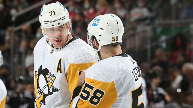 NEWARK, NJ - FEBRUARY 13: Evgeni Malkin #71 and Kris Letang #58 of the Pittsburgh Penguins talk against the New Jersey Devils during the game at Prudential Center on February 13, 2022 in Newark, New Jersey.