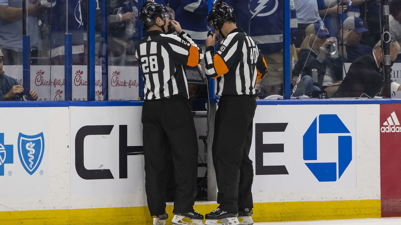 TAMPA, FL - MAY 23: Referees Chris Lee #28 and Steve Kozari #40 review a goal by the Tampa Bay Lightning against the Florida Panthers that is eventually called off during the second period in Game Four of the Second Round of the 2022 Stanley Cup Playoffs at Amalie Arena on May 23, 2022 in Tampa, Florida.