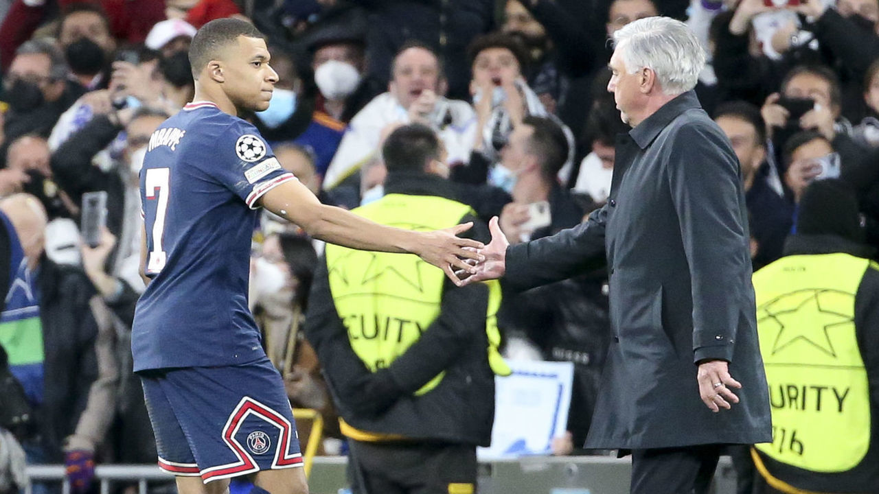 MADRID, SPAIN - MARCH 9: Kylian Mbappe of PSG salutes coach of Real Madrid Carlo Ancelotti following the UEFA Champions League Round Of Sixteen Leg Two match between Real Madrid and Paris Saint-Germain (PSG) at Estadio Santiago Bernabeu on March 9, 2022 in Madrid, Spain.