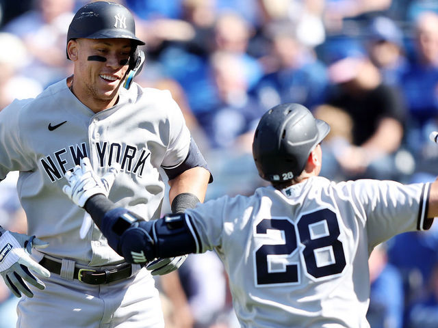KANSAS CITY, MISSOURI - MAY 01: Aaron Judge #99 of the New York Yankees is congratulated by Josh Donaldson #28 after hitting a solo home run during the 9th inning of the game against the Kansas City Royals at Kauffman Stadium on May 01, 2022 in Kansas City, Missouri.