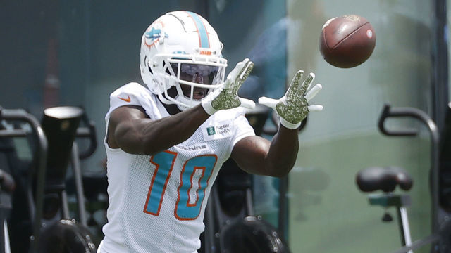 MIAMI GARDENS, FL - MAY 24: Tyreek Hill #10 of the Miami Dolphins catches the ball during the Miami Dolphins OTAs at the Baptist Health Training Complex on May 24, 2022 in Miami Gardens, Florida.
