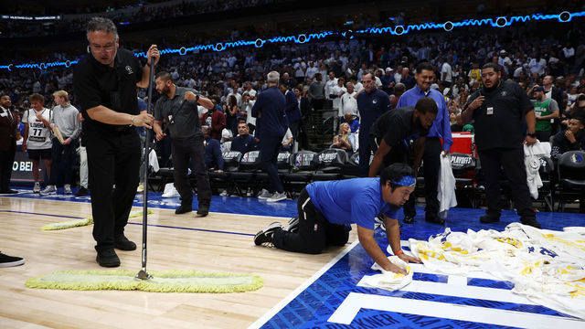 DALLAS, TEXAS - MAY 24: Attendants clean up the leak from the roof that delayed Game Four of the 2022 NBA Playoffs Western Conference Finals between the Golden State Warriors and the Dallas Mavericks at American Airlines Center on May 24, 2022 in Dallas, Texas.