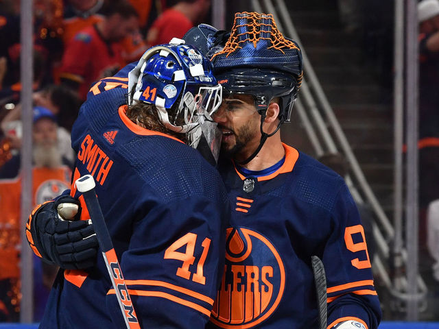 EDMONTON, AB - MAY 24: Mike Smith #41 and Evander Kane #91 of the Edmonton Oilers celebrate after winning Game Four of the Second Round of the 2022 Stanley Cup Playoffs against the Calgary Flames on May 24, 2022 at Rogers Place in Edmonton, Alberta, Canada.