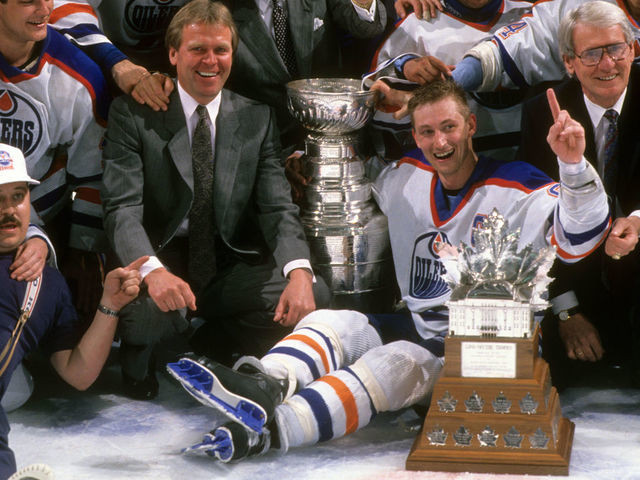 Hockey: NHL Stanley Cup Finals: Team photo of Edmonton Oilers with coach Glen Sather, owner Peter Pocklington, Grant Fuhr and Wayne Gretzky victorious with Stanley Cup trophy and Conn Smythe Trophy after winning Game 4 and series vs Boston Bruins at Northlands Colesium. This game was continued after power failure two days prior. Edmonton, Canada 5/26/1988 CREDIT: David E. Klutho (Set Number: X36585 TK5 R17 F10 )
