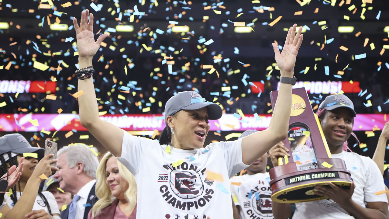 MINNEAPOLIS, MN - APRIL 03: Head coach Dawn Staley of the South Carolina Gamecocks celebrates as Aliyah Boston #4 of the South Carolina Gamecocks raises the trophy after defeating the UConn Huskies during the championship game of the NCAA Women’s Basketball Tournament at Target Center on April 3, 2022 in Minneapolis, Minnesota.