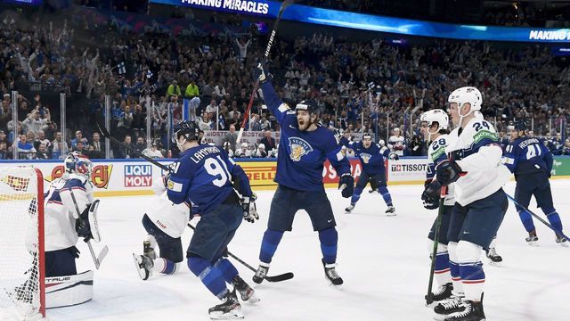 Finland's forward Joel Armia (C) and Finland's forward Juho Lammikko celebrate after Finland's defender Miro Heiskanen (R) scored the 1-1 goal during the IIHF Ice Hockey World Championships half final match between Finland and USA in Tampere, Finland, on May 28, 2022. - - Finland OUT
