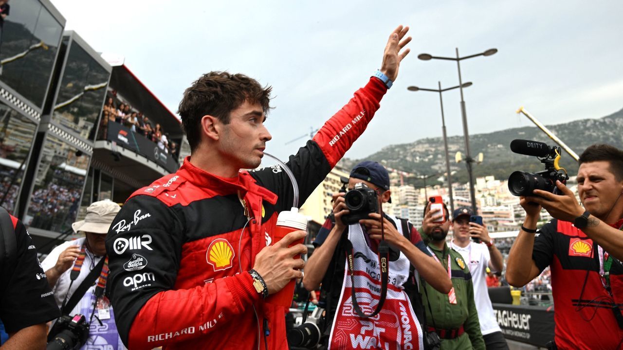Ferrari's Monegasque driver Charles Leclerc waves in the pit area after the qualifying session at the Monaco street circuit in Monaco, ahead of the Monaco Formula 1 Grand Prix, on May 28, 2022.
