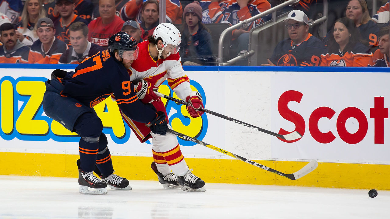 EDMONTON, AB - MAY 24: Connor McDavid #97 of the Edmonton Oilers defends against Johnny Gaudreau #13 of the Calgary Flames during the first period in Game Four of the Second Round of the 2022 Stanley Cup Playoffs at Rogers Place on May 24, 2022 in Edmonton, Canada.
