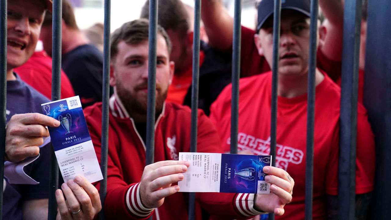 Liverpool fans stuck outside the ground show their match tickets during the UEFA Champions League Final at the Stade de France, Paris. Picture date: Saturday May 28, 2022.