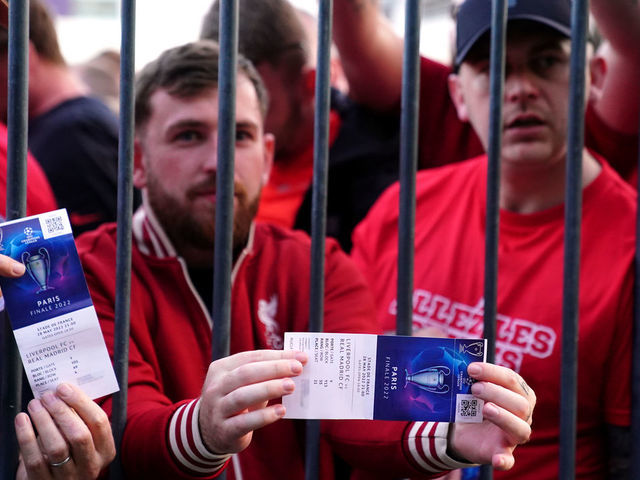 Liverpool fans stuck outside the ground show their match tickets during the UEFA Champions League Final at the Stade de France, Paris. Picture date: Saturday May 28, 2022.