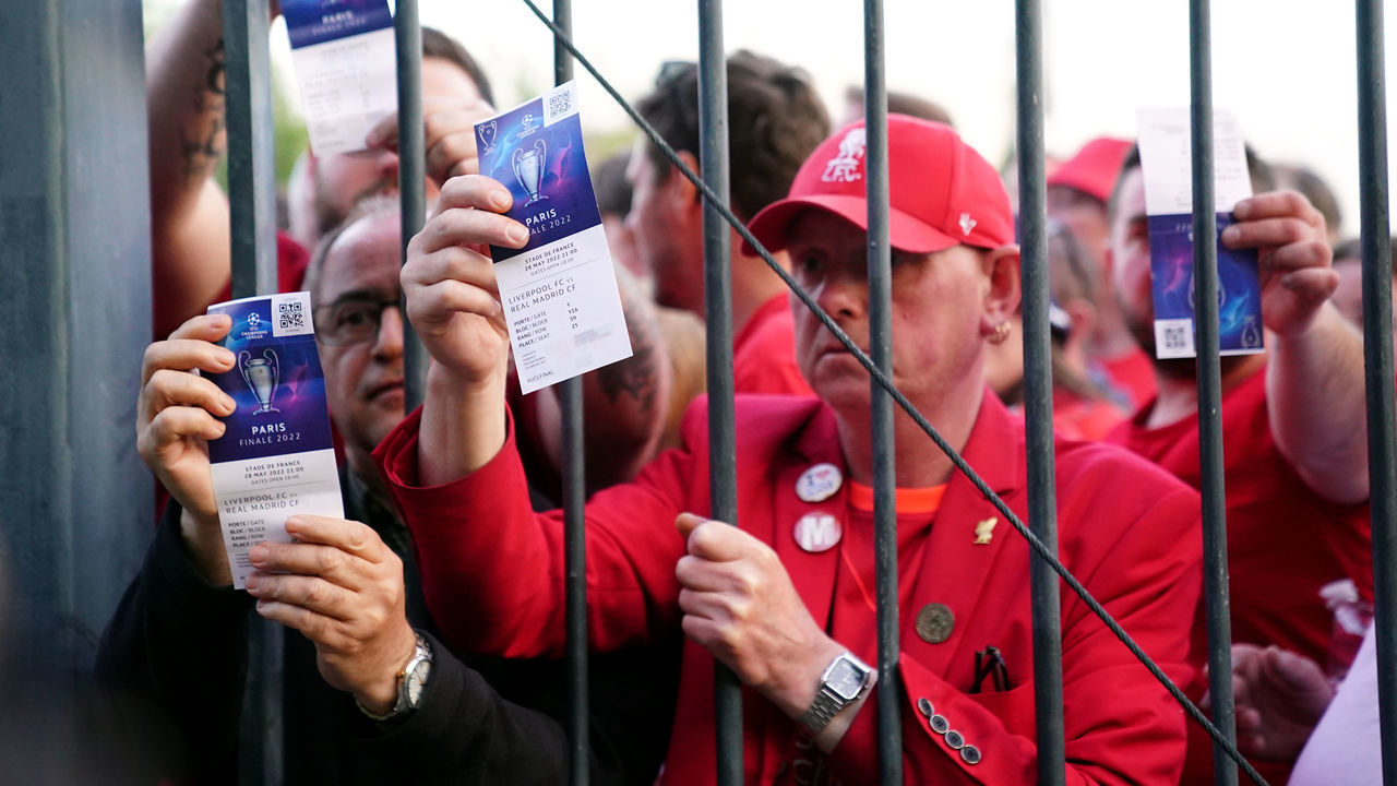 Liverpool fans stuck outside the ground show their match tickets during the UEFA Champions League Final at the Stade de France, Paris. Picture date: Saturday May 28, 2022.