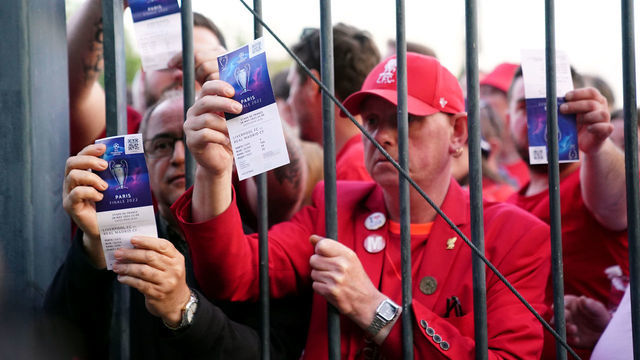 Liverpool fans stuck outside the ground show their match tickets during the UEFA Champions League Final at the Stade de France, Paris. Picture date: Saturday May 28, 2022.