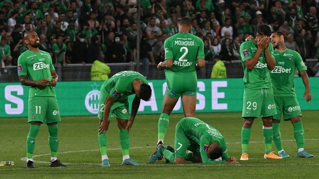 Saint-Etienne's Brazilian defender Gabriel Silva (L) and teammates react after being defeated by Auxerre at the end of the French L1-L2 play-off second leg football match between AS Saint-Etienne and AJ Auxerre at the Geoffroy Guichard Stadium in Saint-Etienne, central-eastern France on May 29, 2022.