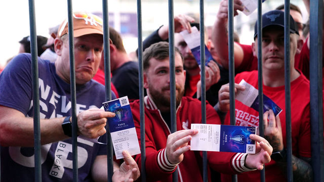 Liverpool fans stuck outside the ground show their match tickets during the UEFA Champions League Final at the Stade de France, Paris. Picture date: Saturday May 28, 2022.