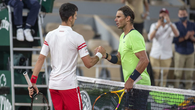PARIS, FRANCE June 11. Winner Novak Djokovic of Serbia is congratulated at the net by Rafael Nadal of Spain after their match on Court Philippe-Chatrier during the semi finals of the singles competition at the 2021 French Open Tennis Tournament at Roland Garros on June 11th 2021 in Paris, France.