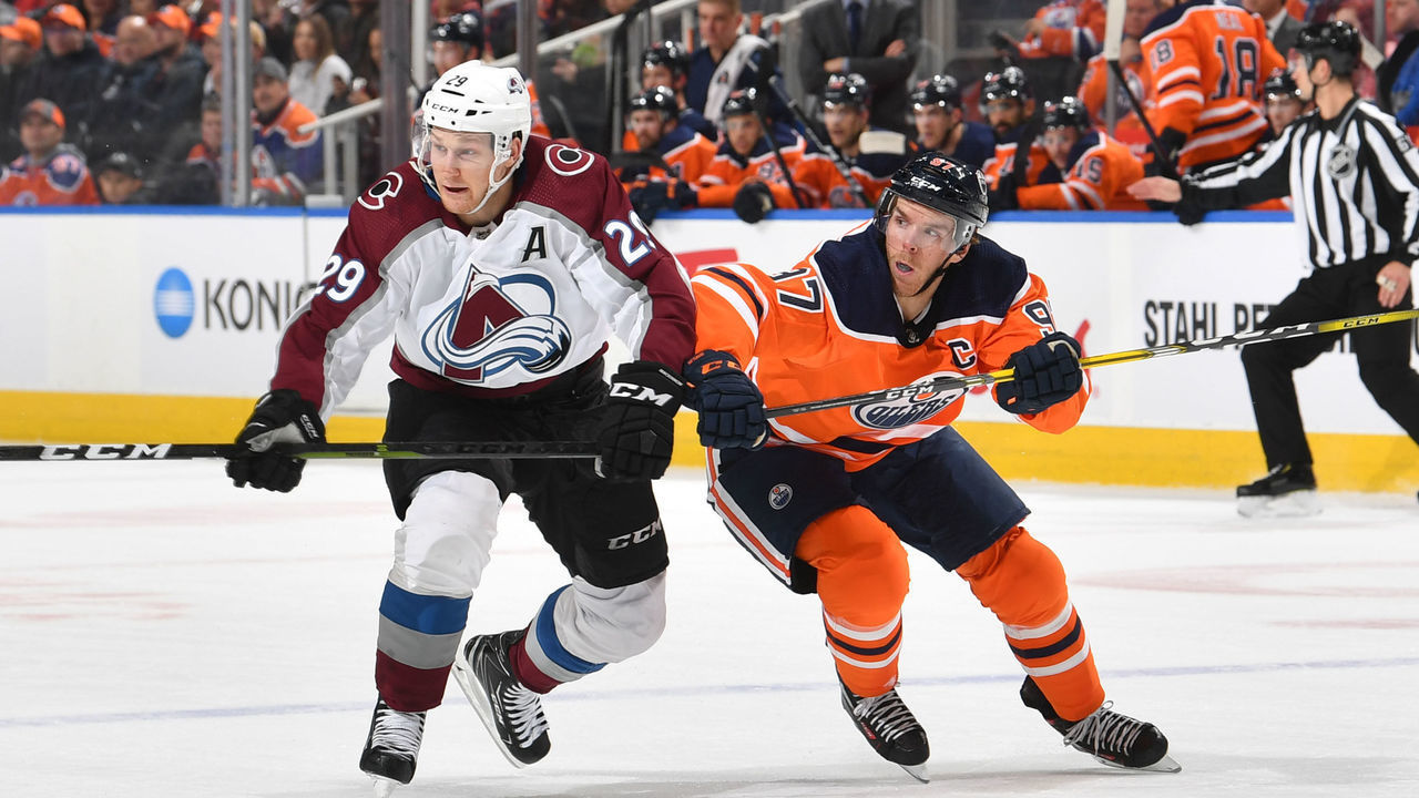 EDMONTON, AB - NOVEMBER 14: Connor McDavid #97 of the Edmonton Oilers races for the puck against Nathan MacKinnon #29 of the Colorado Avalanche on November 14, 2019, at Rogers Place in Edmonton, Alberta, Canada.