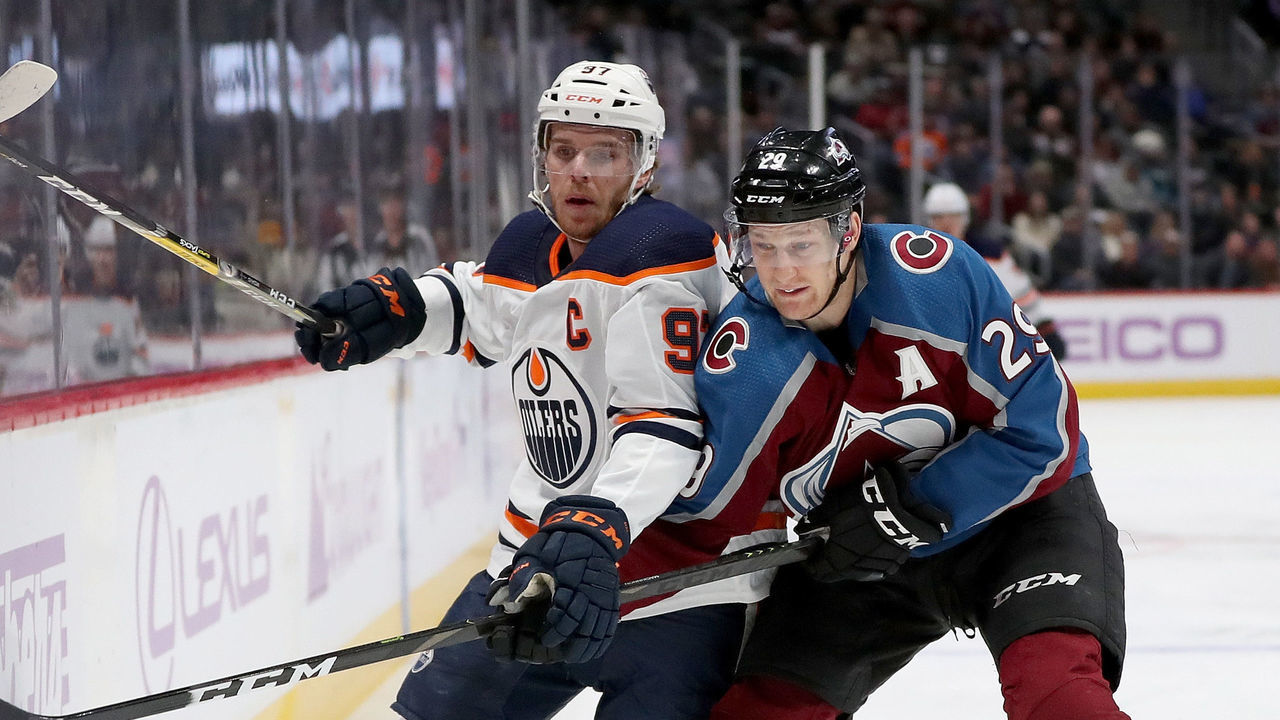 DENVER, COLORADO - NOVEMBER 27: Connor McDavid #97 of the Edmonton Oilers fights for the puck against Nathan MacKinnon #29 of the Colorado Avalanche in the first period at the Pepsi Center on November 27, 2019 in Denver, Colorado.