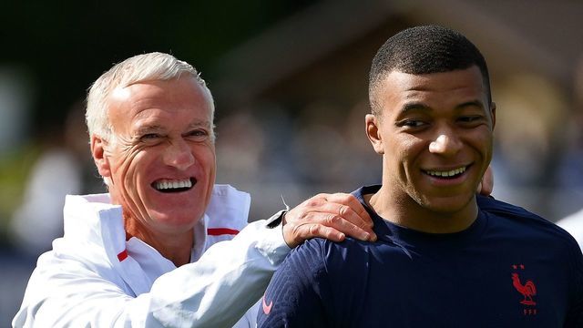 France's head coach Didier Deschamps (L) jokes with France's forward Kylian Mbappe during a training session in Clairefontaine-en-Yvelines on May 30, 2022 as part of the team's preparation for the upcoming UEFA Nations League.