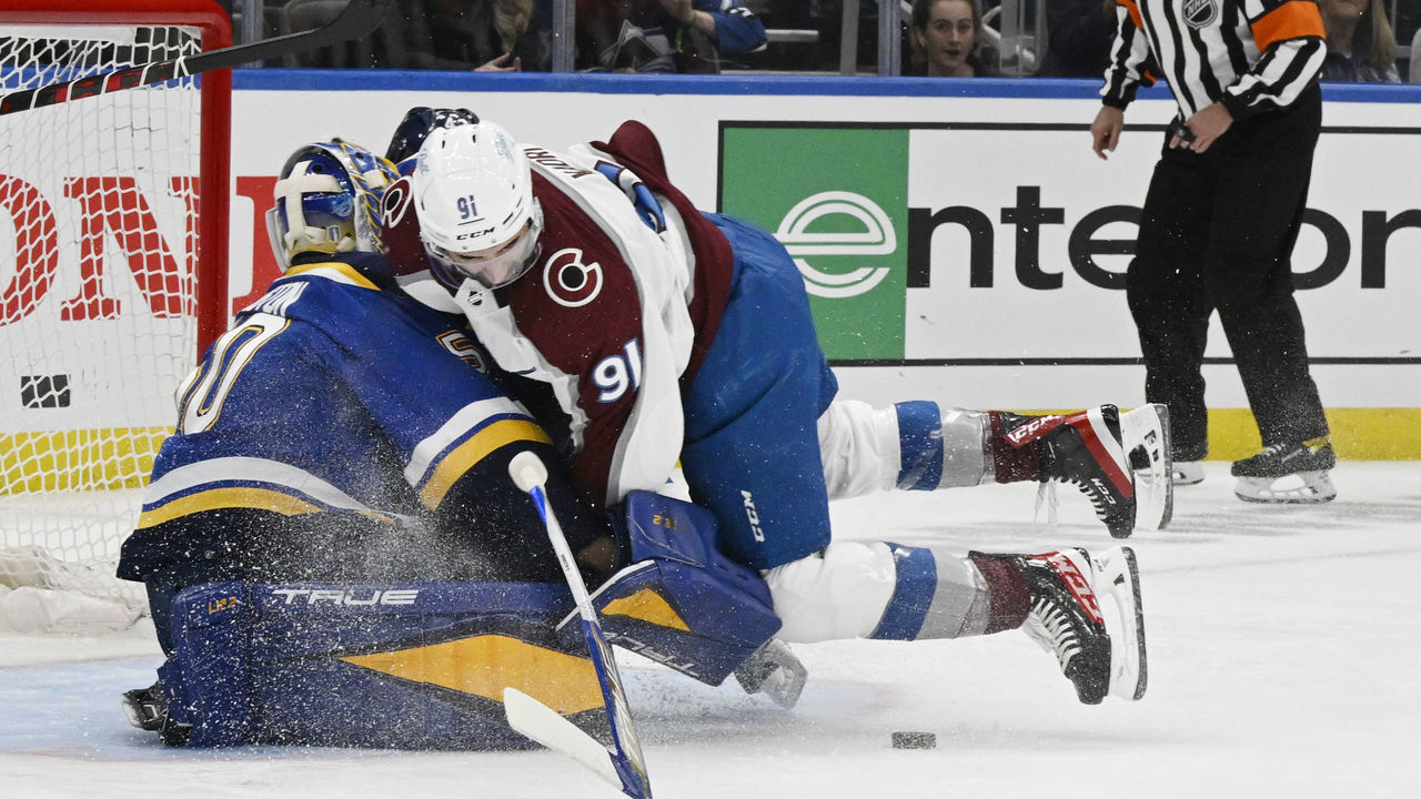 ST. LOUIS, CO - MAY 21: Colorado Avalanche center Nazem Kadri (91) smashes into St. Louis Blues goaltender Jordan Binnington (50) in the first period at The Enterprise Center during game three of the second round of the NHL playoffs at the Enterprise Center May 21, 2022. Binnington left the game with an injury. "n