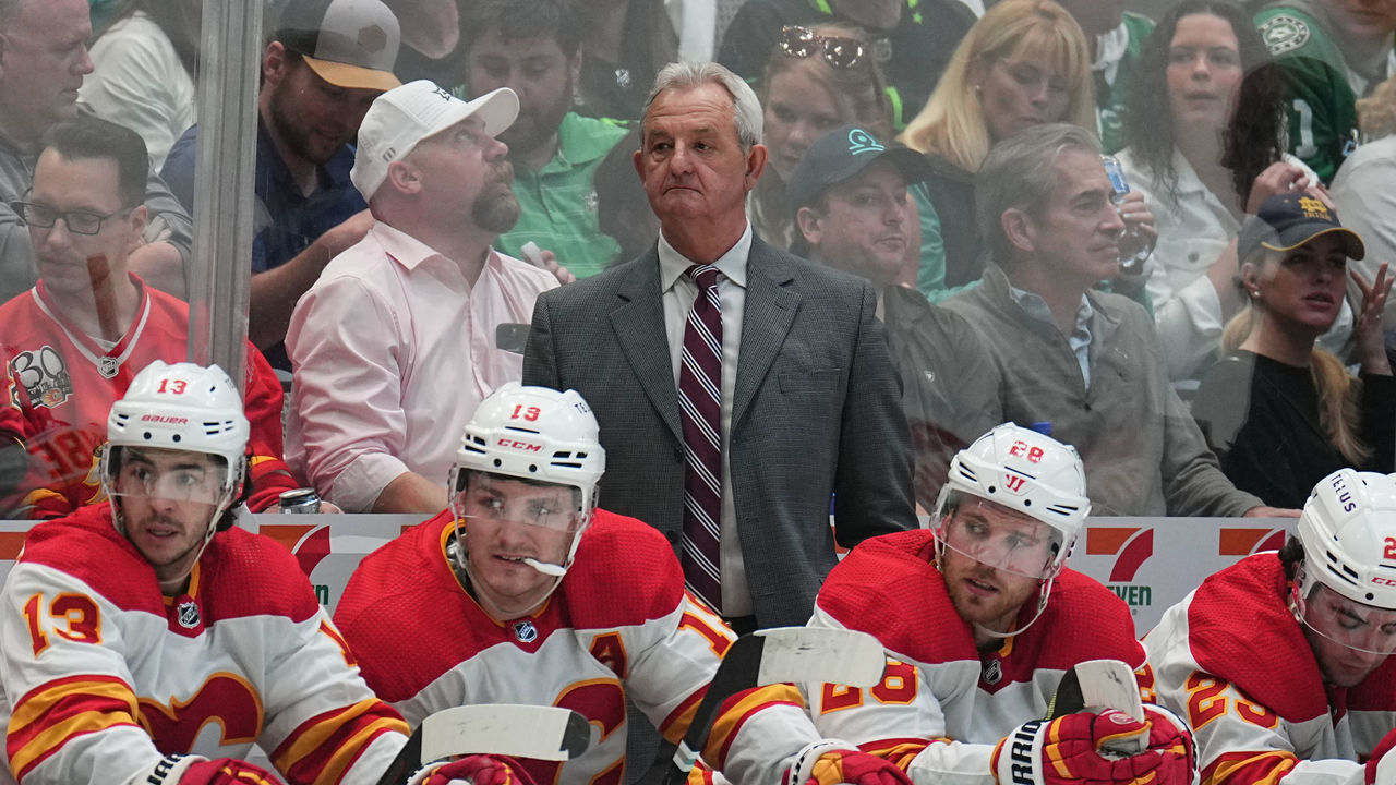 DALLAS, TX - MAY 7: Darryl Sutter pf the Calgary Flames watches the action from behind the bench against the Dallas Stars in Game Three of the First Round of the 2022 Stanley Cup Playoffs at the American Airlines Center on May 7, 2022 in Dallas, Texas.