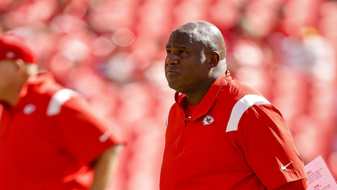 KANSAS CITY, MO - SEPTEMBER 26: Kansas City Chiefs offensive coordinator Eric Bieniemy, right, watches pregame warmups as head coach Andy Reid, left, looks on prior to the game against the Los Angeles Chargers at Arrowhead Stadium on September 26, 2021 in Kansas City, Missouri.