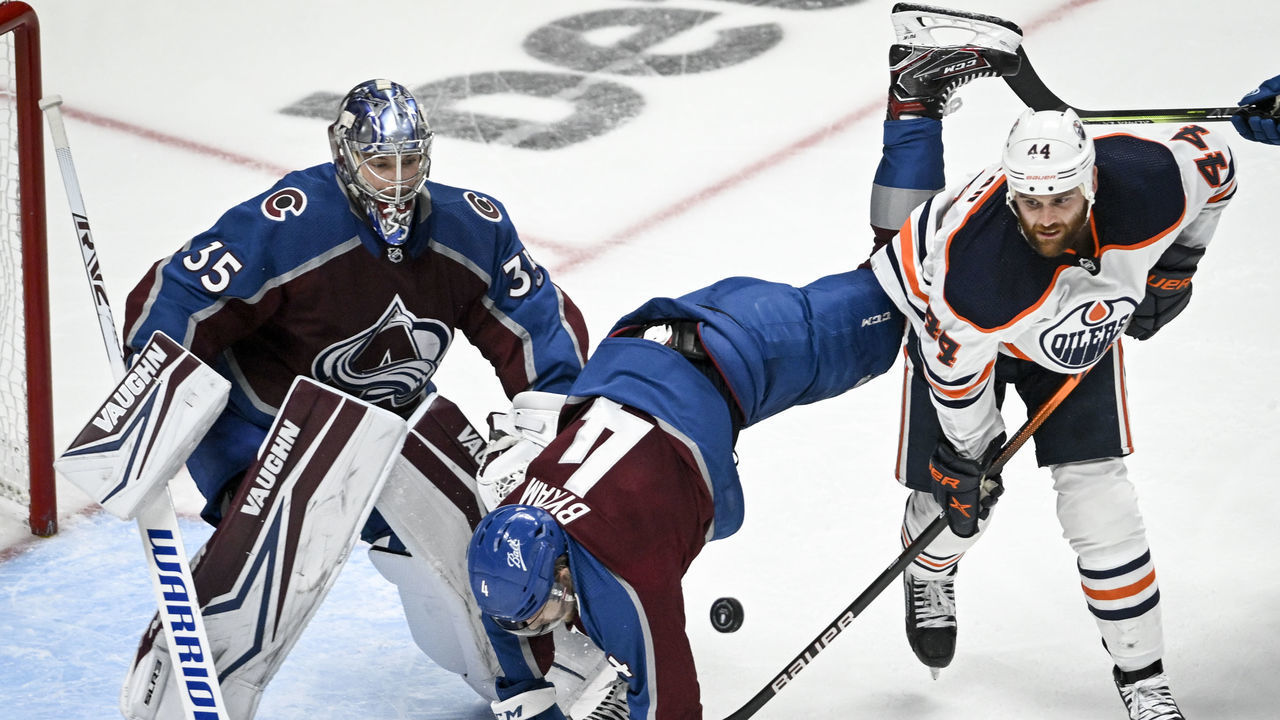 DENVER, CO - MAY 31: Zack Kassian (44) of the Edmonton Oilers upends Bowen Byram (4) of the Colorado Avalanche as Darcy Kuemper (35) tends the net during the second period at Ball Arena on Monday, May 31, 2022. The Avalanche hosted the Oilers in Game one of the best-of-seven Western Conference Finals.