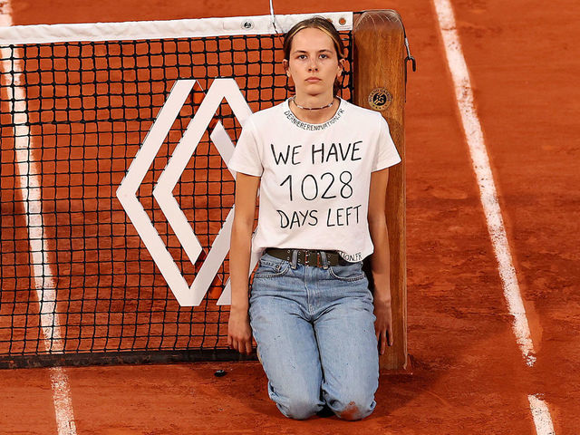 PARIS, FRANCE - JUNE 03: A protester ties themselves to the net during the Men's Singles Semi Final match between Marin Cilic of Croatia and Casper Ruud of Norway on Day 13 of The 2022 French Open at Roland Garros on June 03, 2022 in Paris, France.
