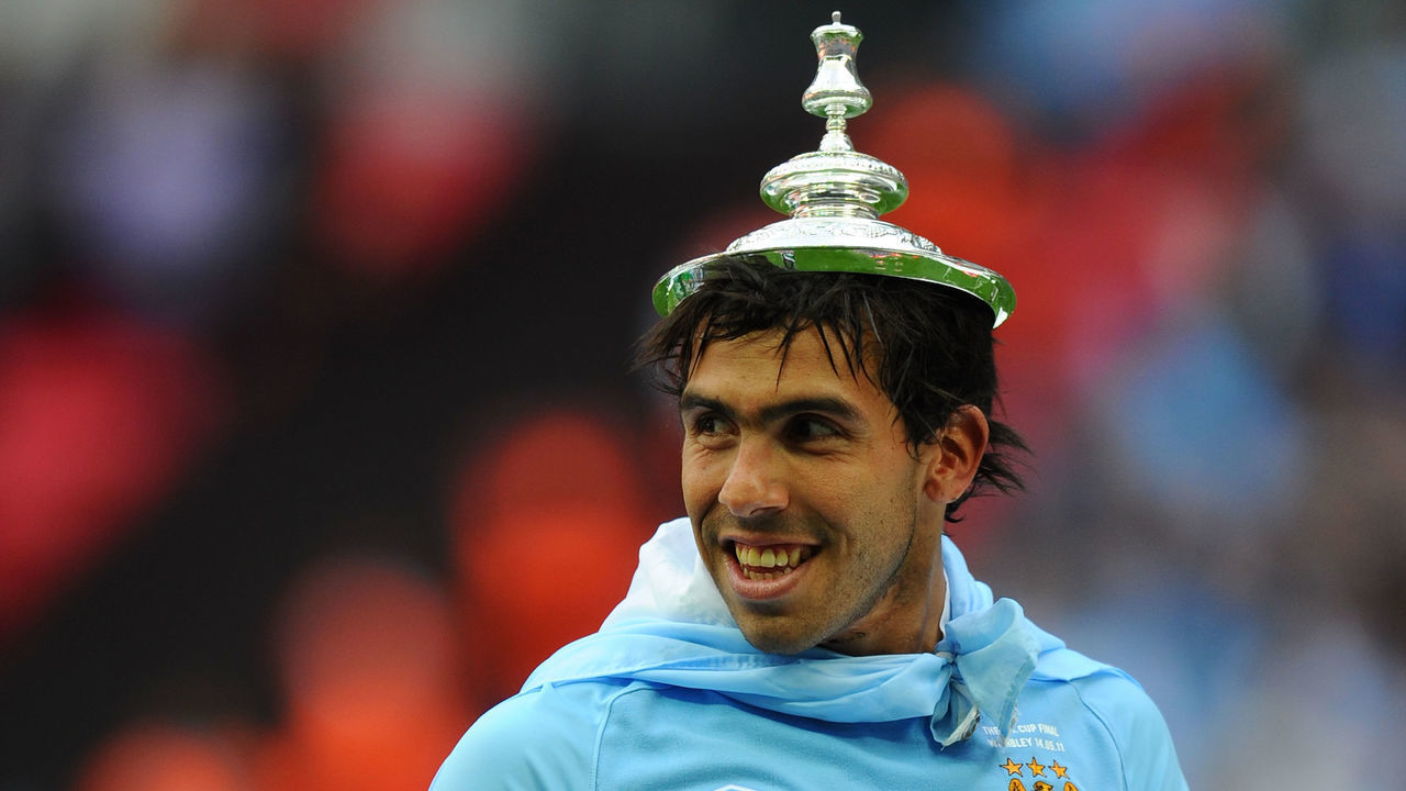 LONDON, ENGLAND - MAY 14: Carlos Tevez of Man City celebrates with the trophy after the The FA Cup sponsored by E.0N 2011 Final match between Manchester City and Stoke City at Wembley Stadium on May 14, 2011 in London, England.
