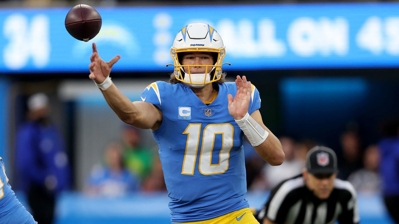 INGLEWOOD, CALIFORNIA - JANUARY 02: Justin Herbert #10 of the Los Angeles Chargers completes a pass in the fourth quarter over the Denver Broncos at SoFi Stadium on January 02, 2022 in Inglewood, California.