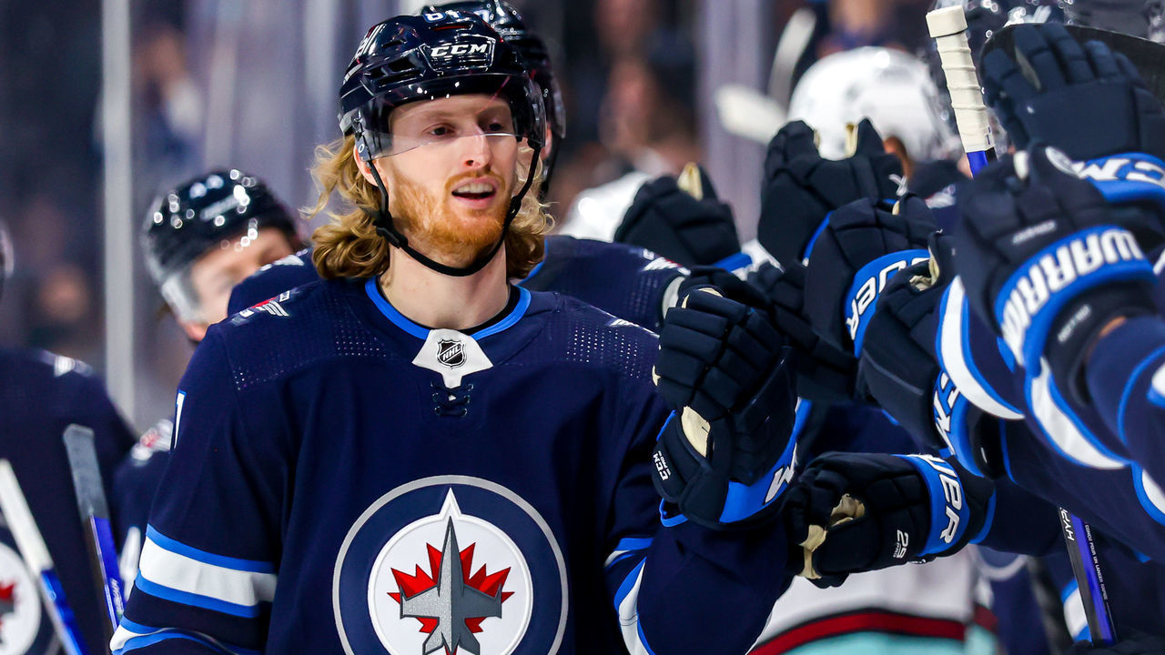 WINNIPEG, MB - MAY 01: Kyle Connor #81 of the Winnipeg Jets skates by the bench to celebrate his third period goal against the Seattle Kraken at Canada Life Centre on May 01, 2022 in Winnipeg, Manitoba, Canada.