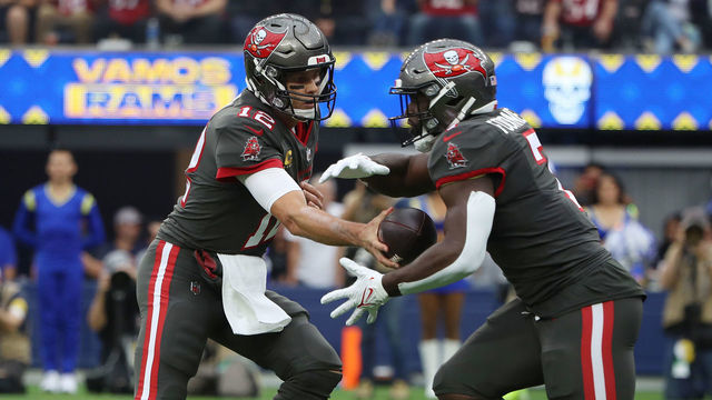 INGLEWOOD, CALIFORNIA - SEPTEMBER 26: Tom Brady #12 of the Tampa Bay Buccaneers hands the ball to Leonard Fournette #7 during the first quarter in the game against the Los Angeles Rams at SoFi Stadium on September 26, 2021 in Inglewood, California.