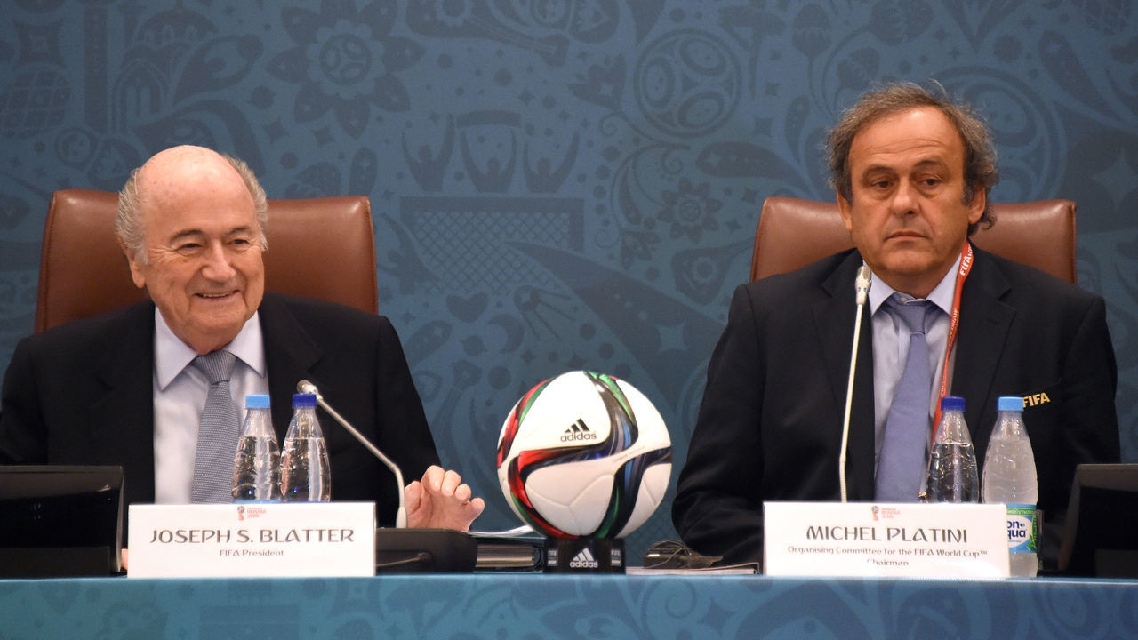 FIFA President Joseph Blatter (L) smiles as he sits next to UEFA President Michel Platini (R) as they join a seminar ahead of the Preliminary Draw for the FIFA World Cup 2018, in St.Petersburg, Russia, 25 July 2015. Photo: MARCUS BRANDT/dpa | usage worldwide