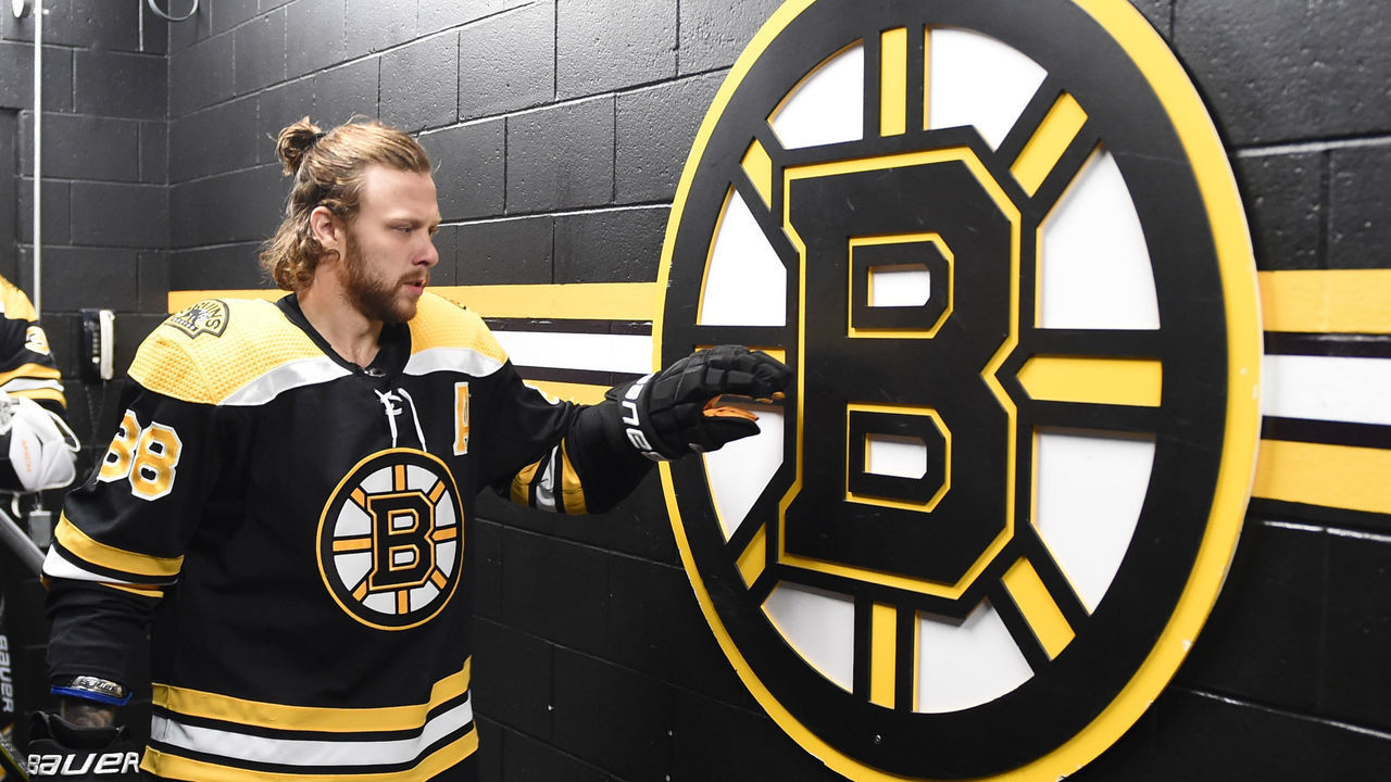 BOSTON, MA - MAY 12: David Pastrnak #88 of the Boston Bruins touches the team logo while heading out to warm up before the game against the Carolina Hurricanes in Game Six of the First Round of the 2022 Stanley Cup Playoffs at the TD Garden on May 12, 2022 in Boston, Massachusetts.