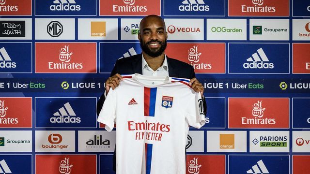 Former France international Alexandre Lacazette poses with his jersey during a press conference to announce his return to Ligue 1 Olympique Lyonnais (OL) football club, on June 9, 2022 in Decines-Charpieu, central-eastern France. - Lacazette returns to Lyon on a free transfer five years after he joined Arsenal for a then club record fee of £46.5 million ($58 million). The 31-year-old striker underwent a medical before signing a three year contract with the club where he made his name after coming through the youth system.