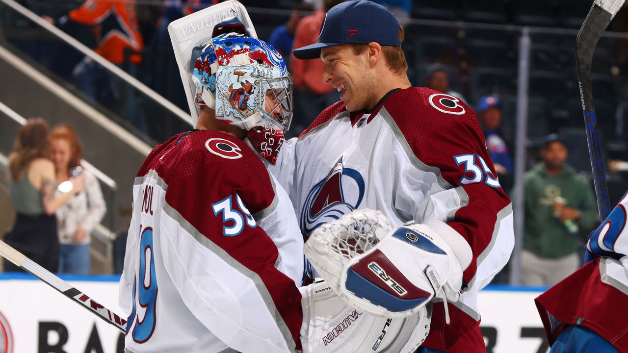 ELMONT, NY - MARCH 07: Pavel Francouz #39 of the Colorado Avalanche celebrates with Darcy Kuemper #35 after getting a 5-4 win against the New York Islanders at UBS Arena on March 7, 2022 in Elmont, New York.