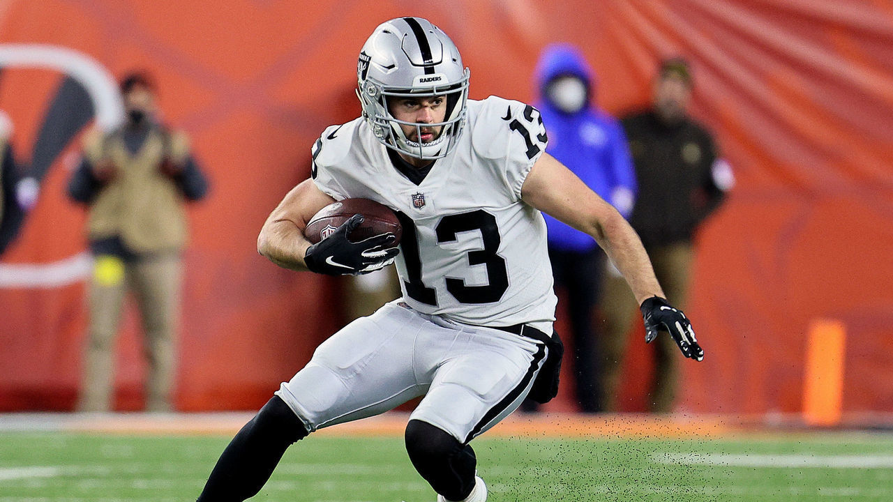 CINCINNATI, OHIO - JANUARY 15: Hunter Renfrow #13 of the Las Vegas Raiders carries the ball against the Cincinnati Bengals during the second half of the AFC Wild Card playoff game at Paul Brown Stadium on January 15, 2022 in Cincinnati, Ohio.