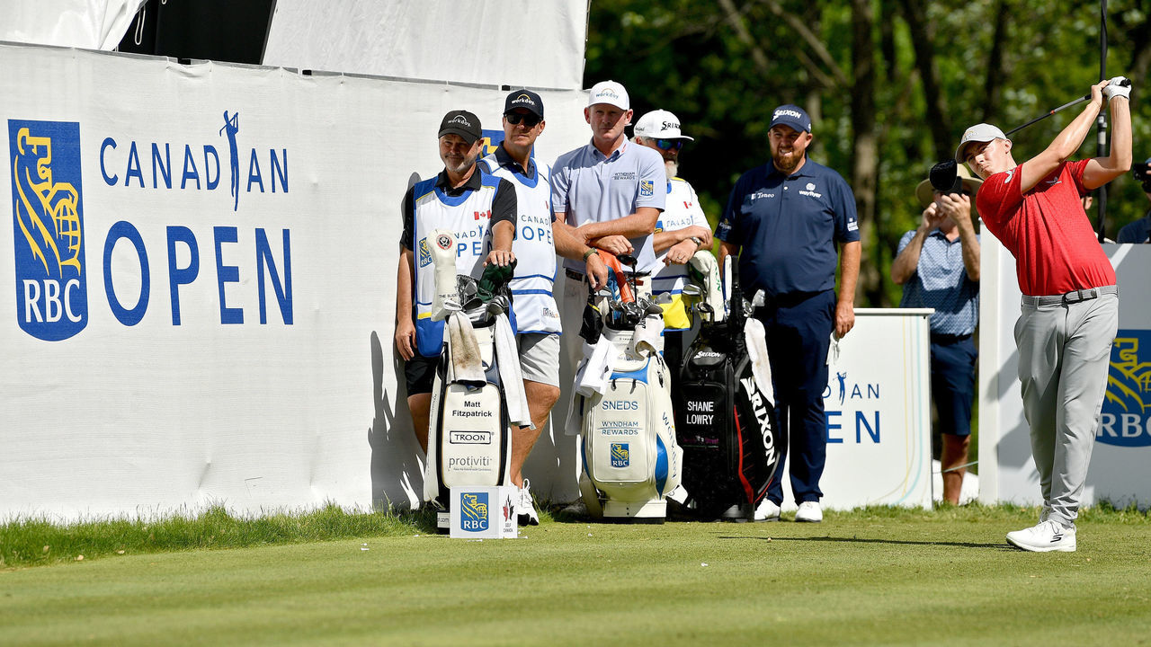 ETOBICOKE, ONTARIO - JUNE 10: Matt Fitzpatrick of England plays his shot from the 12th tee as Brandt Snedeker of the United States and Shane Lowry of Ireland look on during the second round of the RBC Canadian Open at St. George's Golf and Country Club on June 10, 2022 in Etobicoke, Ontario.