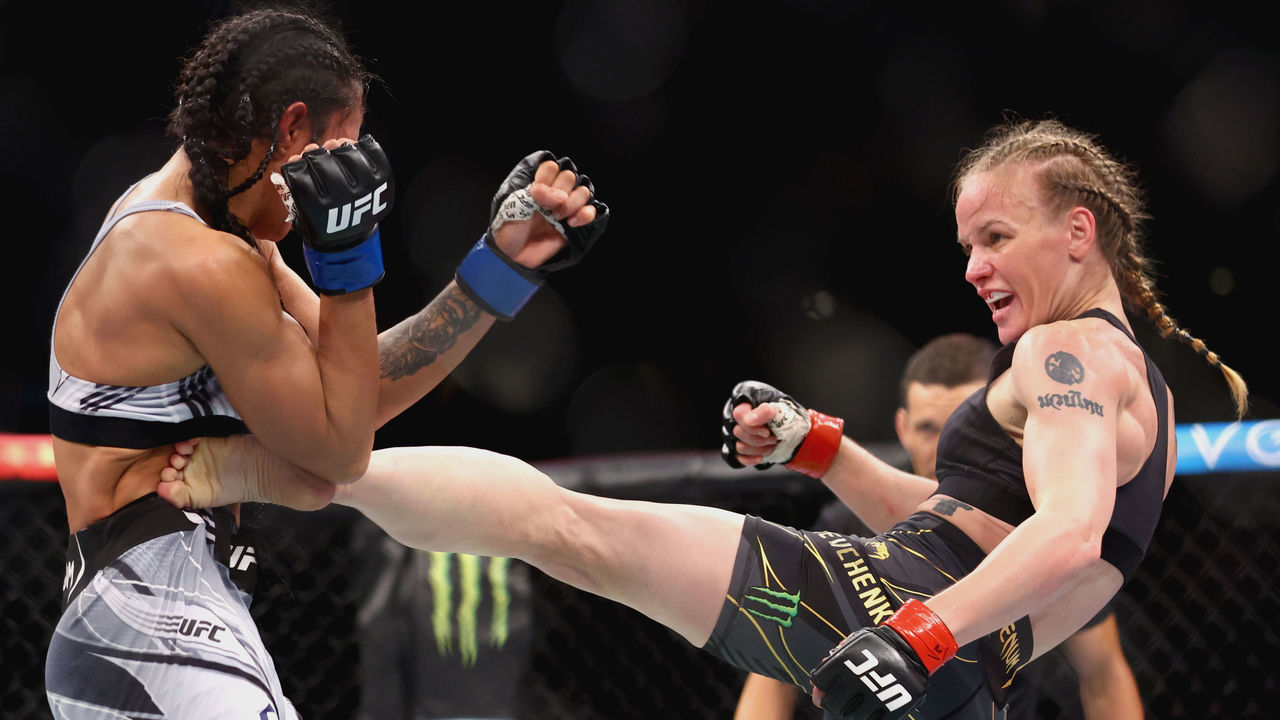 SINGAPORE, SINGAPORE - JUNE 12: Valentina Shevchenko of Kyrgyzstan exchanges strikes with Taila Santos of Brazil during their Women's Flyweight Fight at Singapore Indoor Stadium on June 12, 2022 in Singapore.
