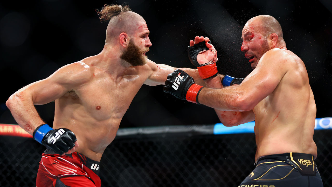 SINGAPORE, SINGAPORE - JUNE 12: Glover Teixeira of Brazil exchanges strikes with Jiri Prochazka of Czech Republic during their light Heavyweight Championship Fight at Singapore Indoor Stadium on June 12, 2022 in Singapore.