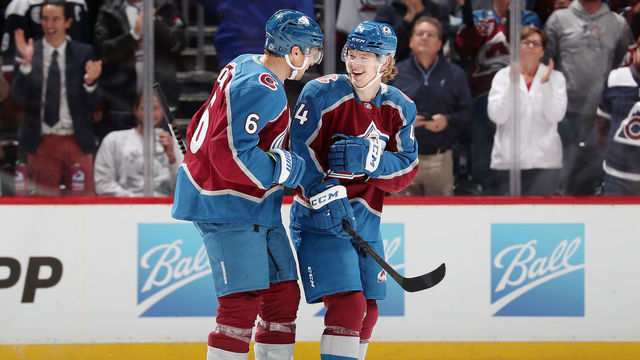 DENVER, COLORADO - OCTOBER 13: Bowen Byram #4 of the Colorado Avalanche celebrates his first career goal against the Chicago Blackhawks with teammate Erik Johnson #6 at Ball Arena on October 13, 2021 in Denver, Colorado.