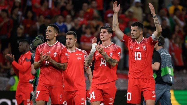Switzerland's players (LtoR) midfielder Noah Okafor, forward Mario Gavranovic, midfielder Steven Zuber and midfielder Granit Xhaka celebrate their victory at the end of the UEFA Nations League - league A group 2 football match between Switzerland and Portugal at Stade de Geneve Stadium in Geneva, on June 12, 2022. - Switzerland won 1-0.
