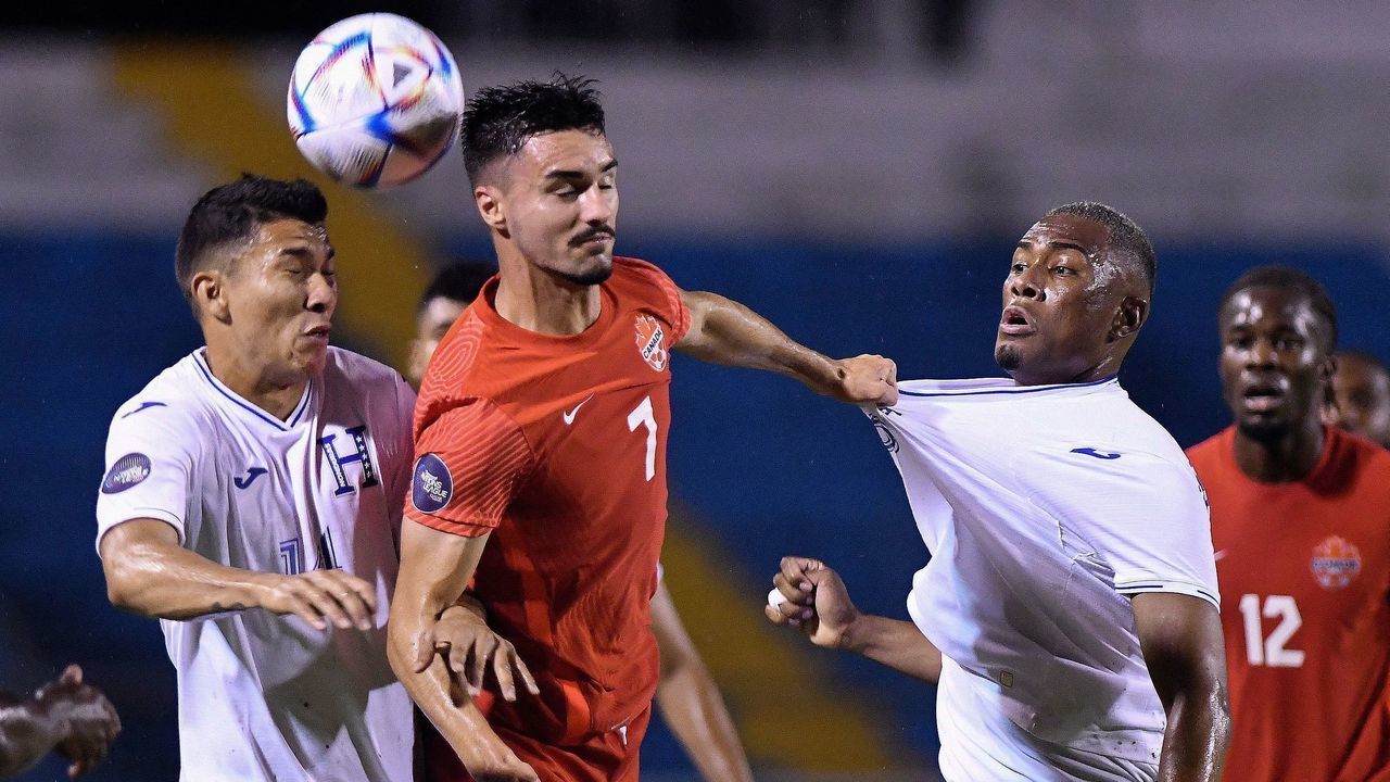 Honduras' Deybi Flores (R) and Kevin Lopez (L) vie for the ball with Canada's Estephen Eustaquio during their CONCACAF Nations League football match at the Olympic Stadium in San Pedro Sula, Honduras, on June 13, 2022.
