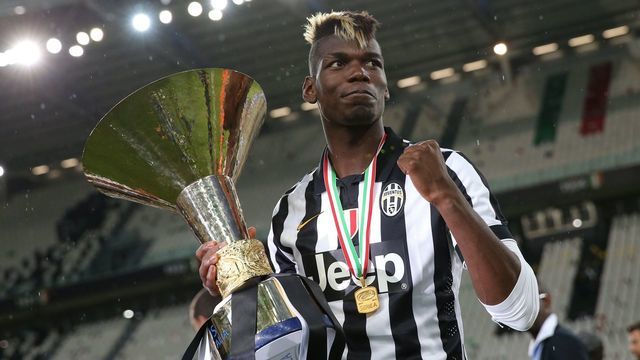 Juventus' midfielder from France Paul Pogba celebrates with the Italian League's trophy during a ceremony following the Italian Serie A football match Juventus vs Napoli on May 23, 2015 at the Juventus stadium in Turin. Juventus won the Coppa Italia on May 20, 2015 and the Italian League today after their 3-1 victory over Napoli. AFP PHOTO / MARCO BERTORELLO