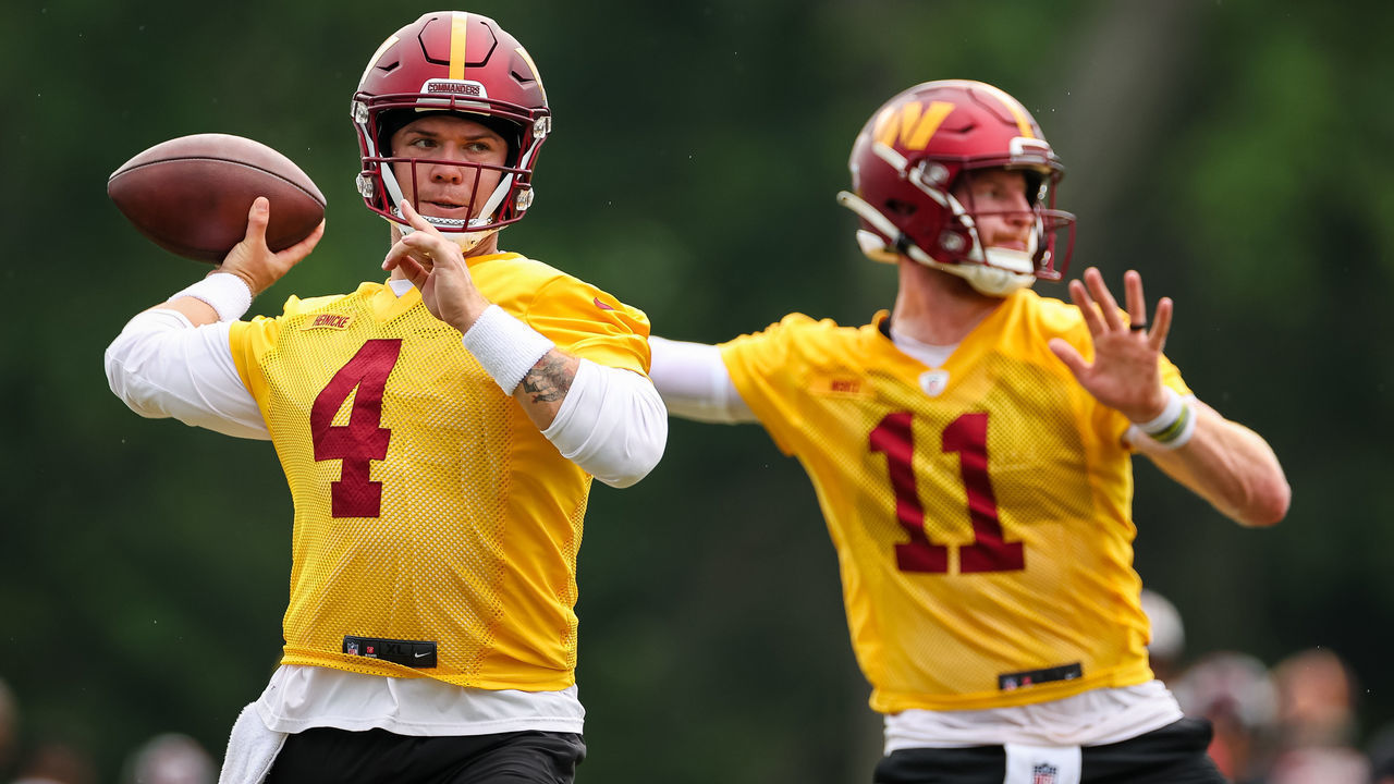 ASHBURN, VA - JUNE 14: Quarterbacks Taylor Heinicke #4 and Carson Wentz #11 of the Washington Commanders participate in a drill during the organized team activity at INOVA Sports Performance Center on June 14, 2022 in Ashburn, Virginia.